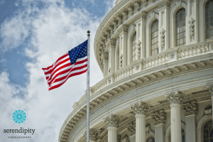 Washington DC Capitol dome detail with American flag waving in the breeze.