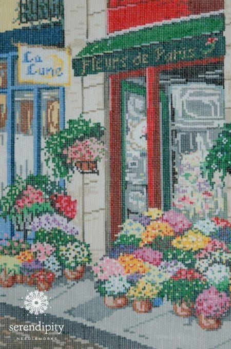 "Fleurs de Paris", a needlepoint canvas by Once in a Blue Moon Designs, depicts a Parisian flower shop.