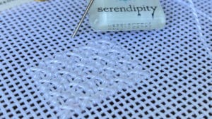 The sample of the rice stitch is worked in white pearl cotton #5.