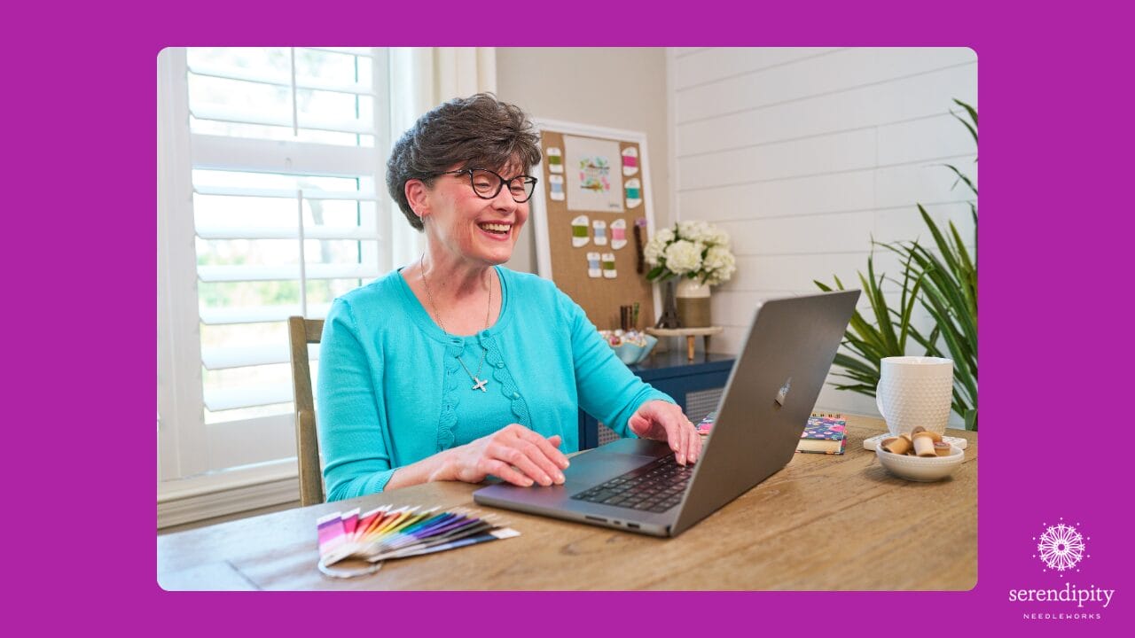 Needlepoint teacher and author Ellen Johnson smiling while teaching online needlepoint classes about choosing stitches and threads for painted canvases 